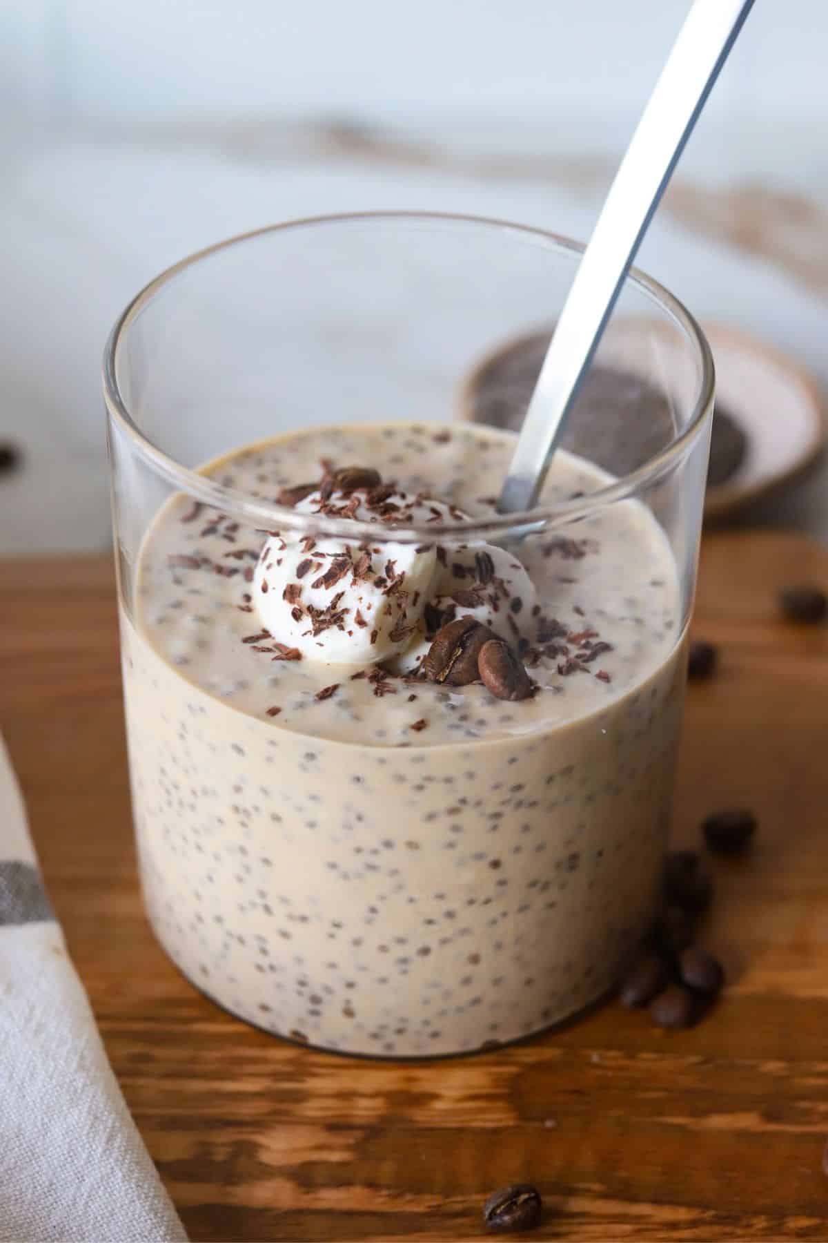 Coffee chia protein pudding in a glass container.