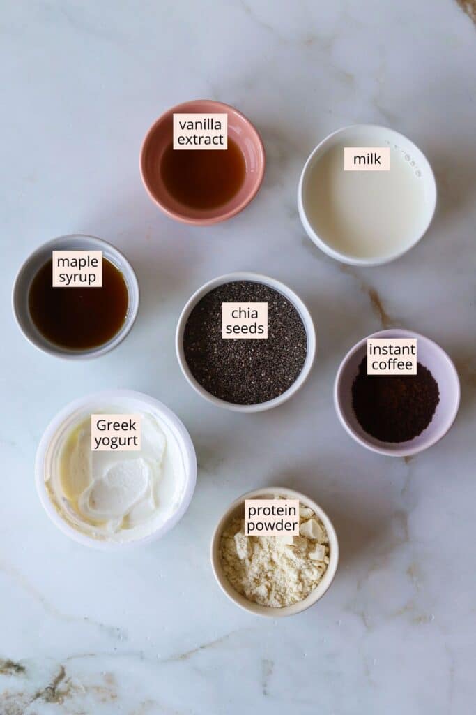 Coffee chia protein pudding ingredients laid out on a countertop with labels.