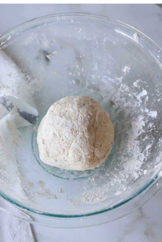 Cottage cheese pizza crust dough ball in a glass bowl.