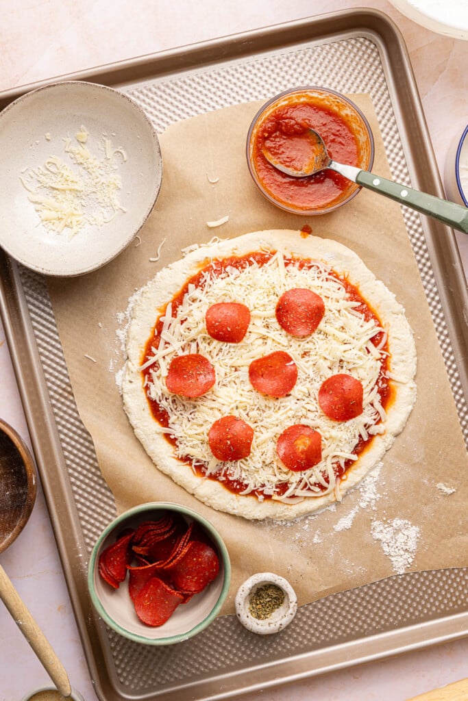 The pepperoni cottage cheese pizza on a piece of parchment paper.