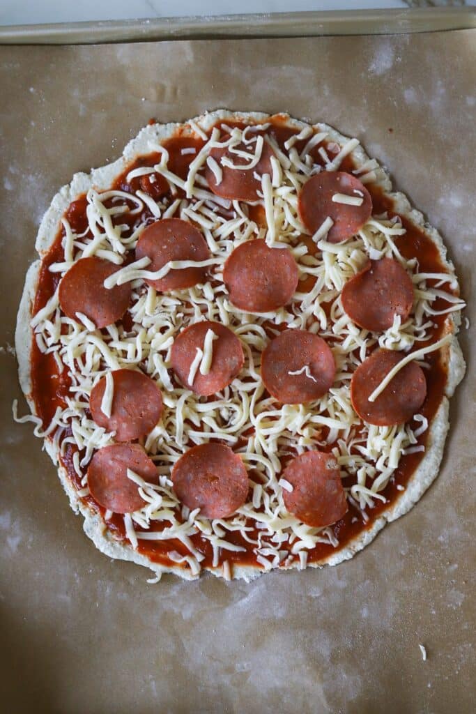 Cottage cheese pizza crust dough topped with tomato sauce, shredded cheese and pepperoni.