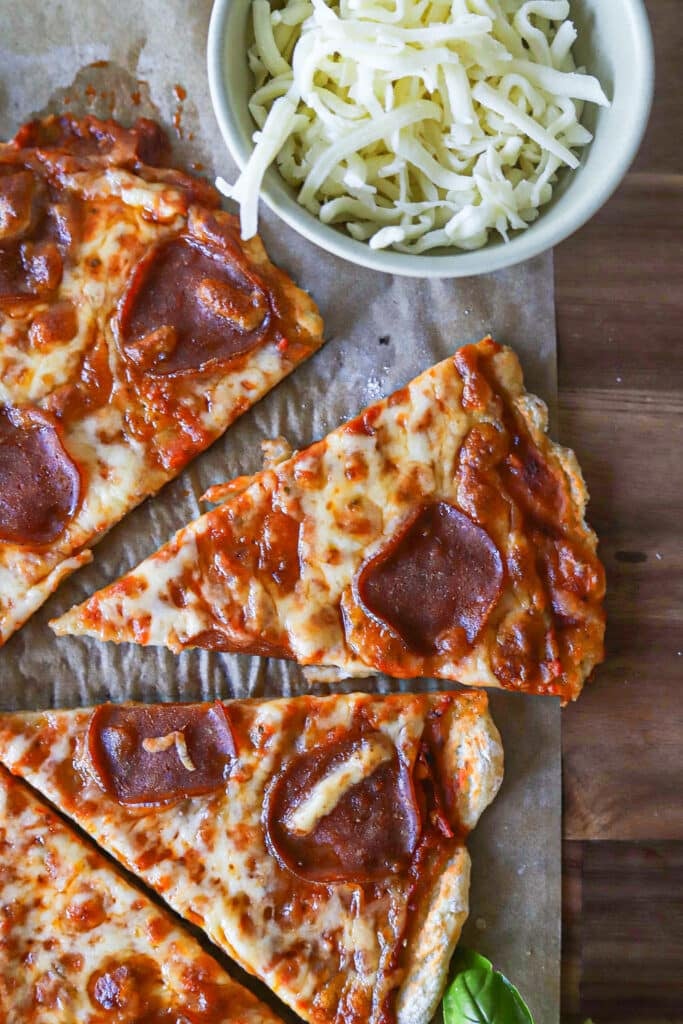 Slices of cottage cheese pizza crust on a wooden board