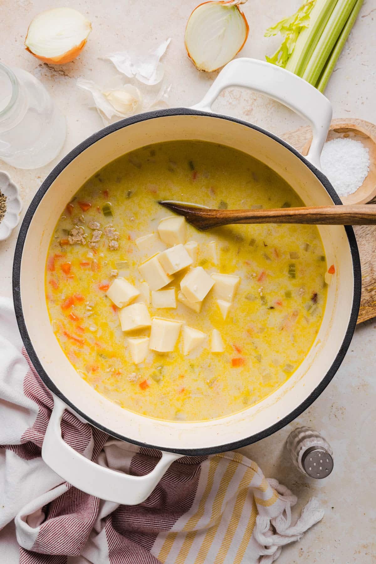 The cheese in the pot with the remaining ingredients before melting.