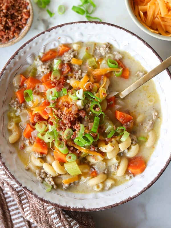 One pot cheeseburger mac soup topped with bacon crumbles and green onions.
