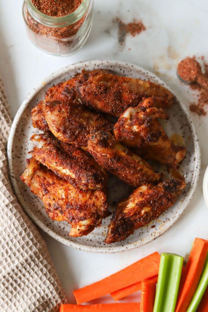 Buffalo chicken wings made with dry rub on a plate.