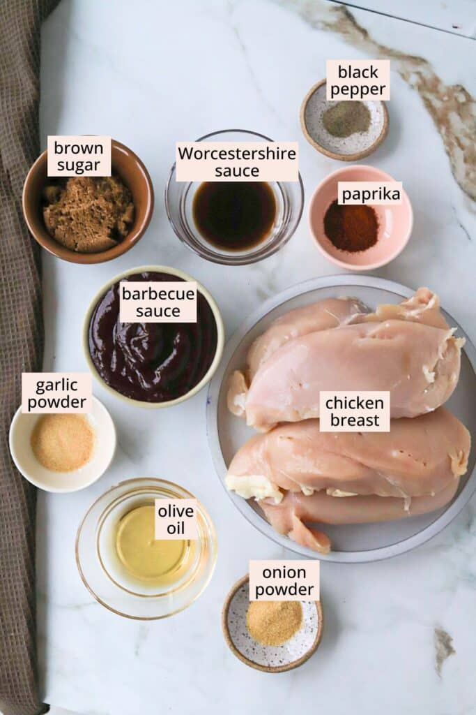 Ingredients for brown sugar BBQ chicken on a countertop with labels.