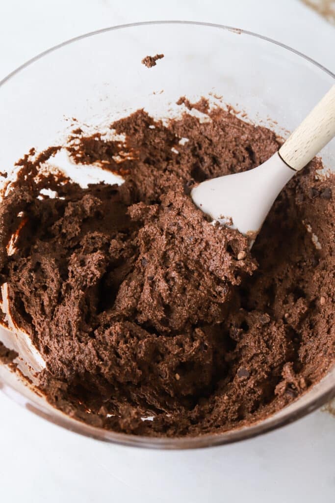 Cottage cheese brownie batter mixed in a bowl.