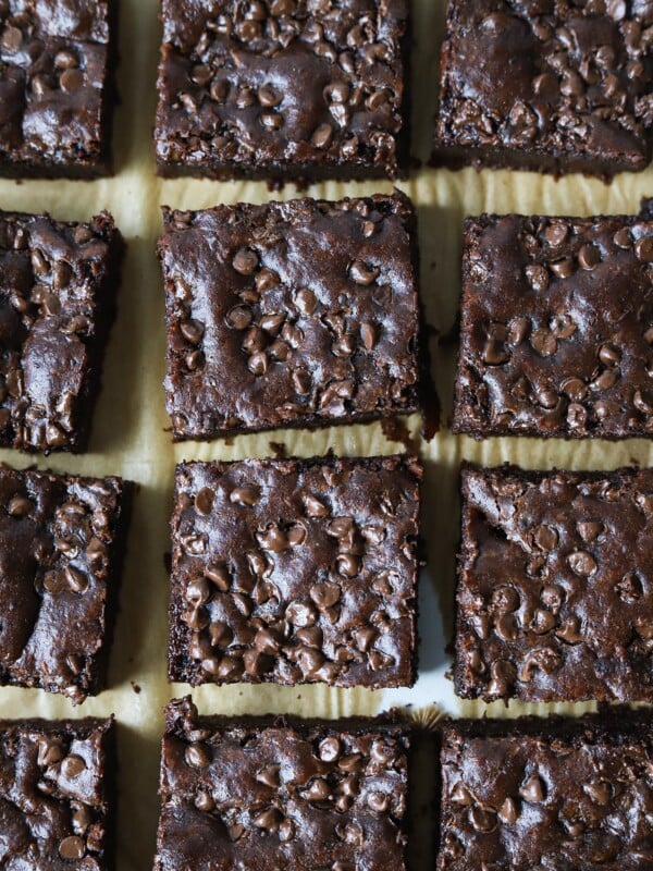 Cottage cheese brownies sliced on parchment paper.