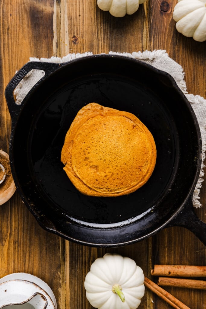 A pumpkin pancake made with pancake mix in a skillet.
