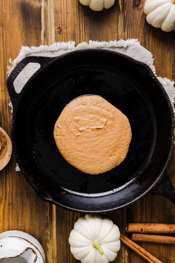 Pumpkin pancake batter poured on a skillet.