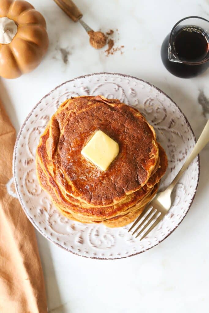 Pumpkin pancakes with pancake mix on a plate with a fork.