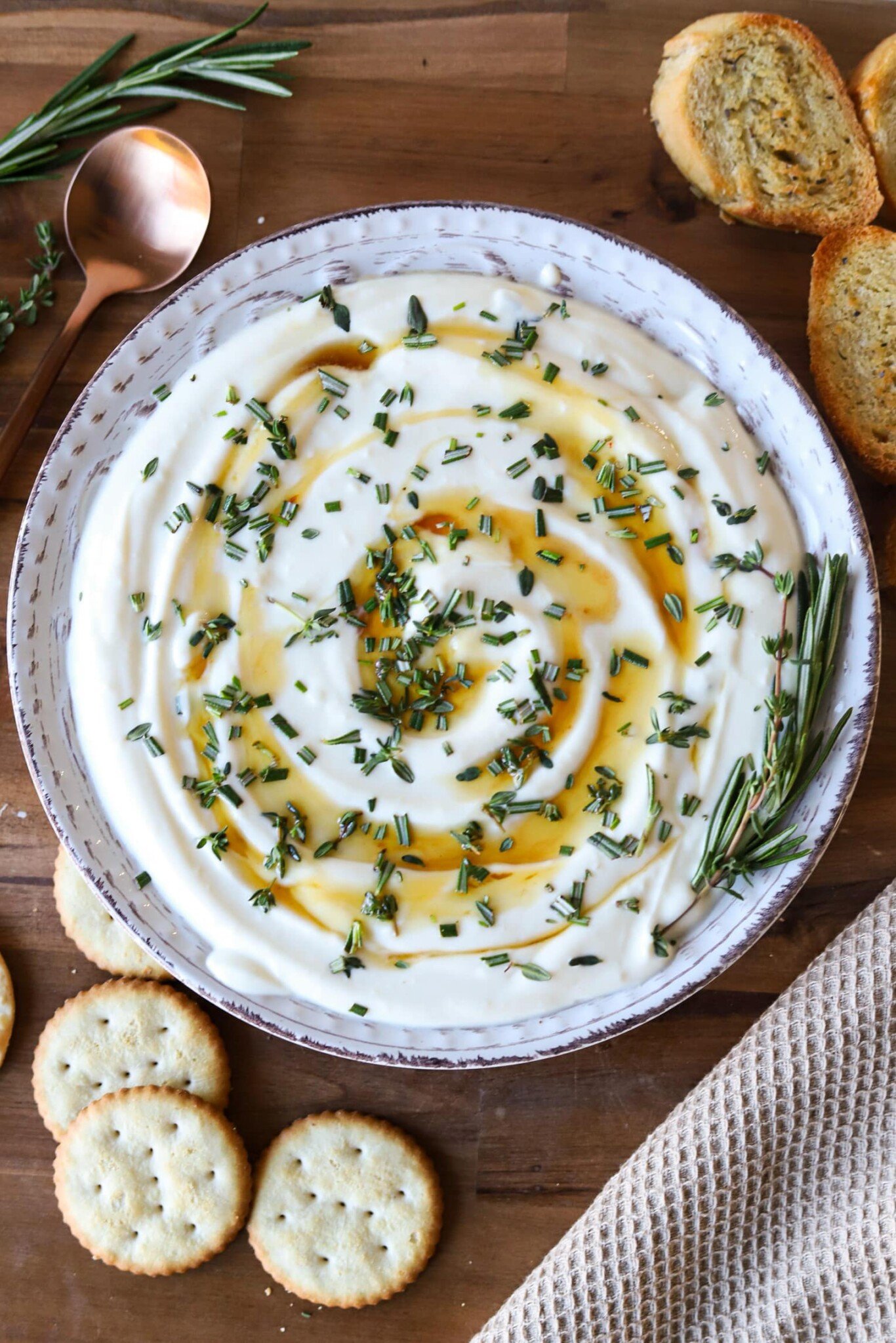 Whipped ricotta dip with honey and fresh herbs served with crackers and crostini.