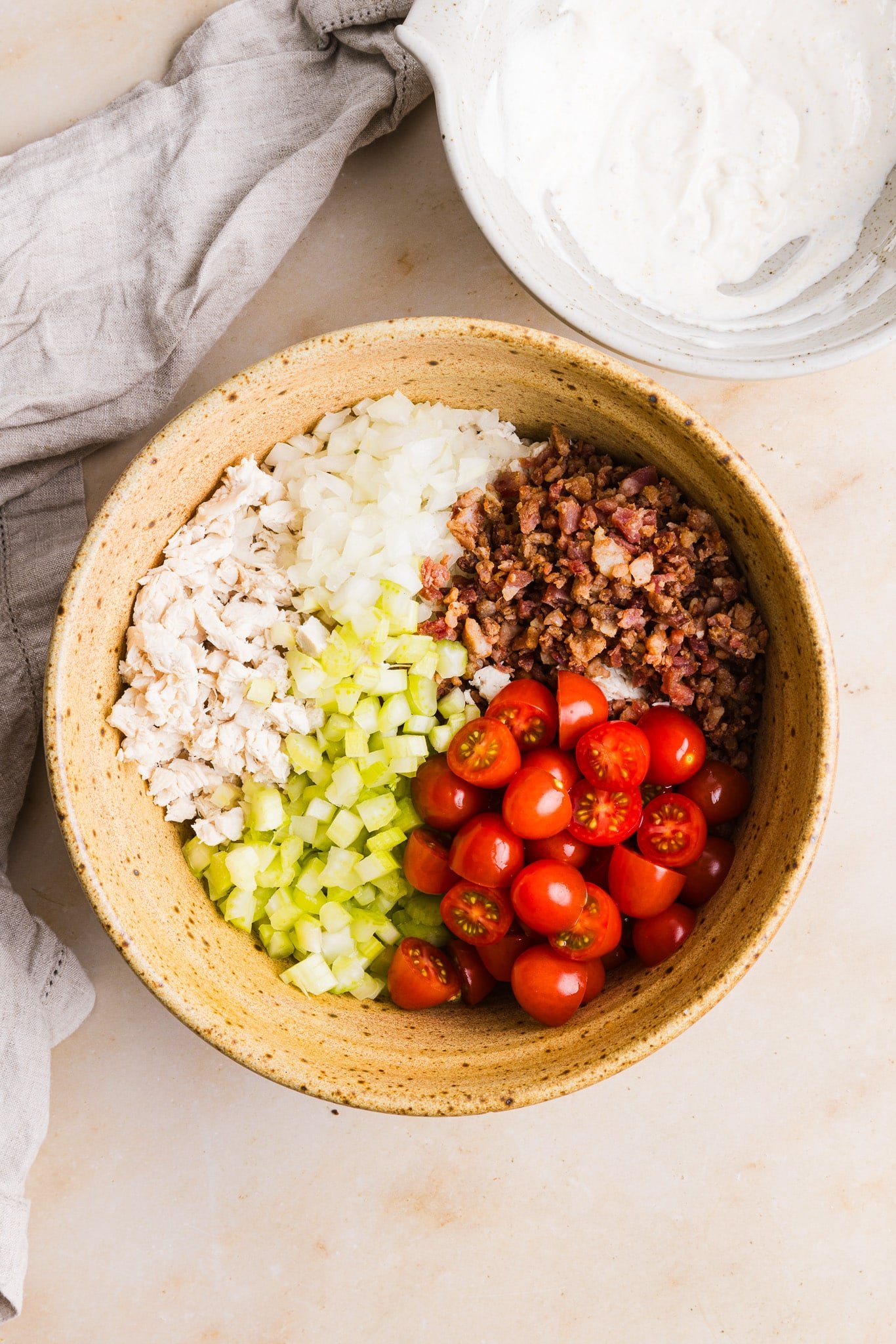 Ingredients for BLT chicken salad in a large bowl.