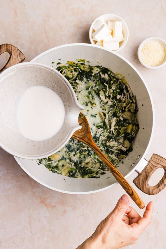 Milk and flour mixture being added to a soup pot.