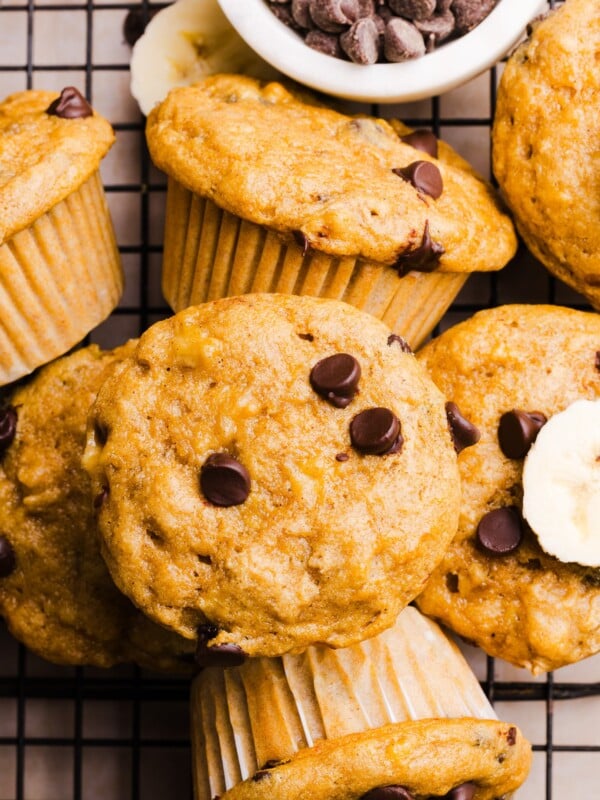 Kodiak banana muffins on a baking rack with chocolate chips.