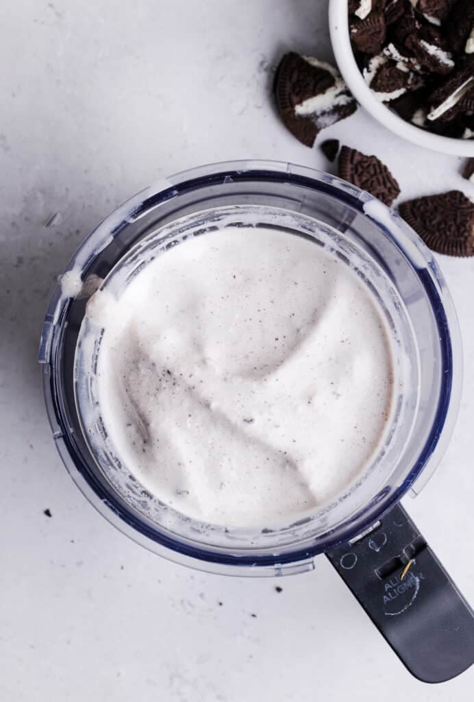 Ninja Creami Oreo milkshake in the pint container and base blended with oreo cookies.