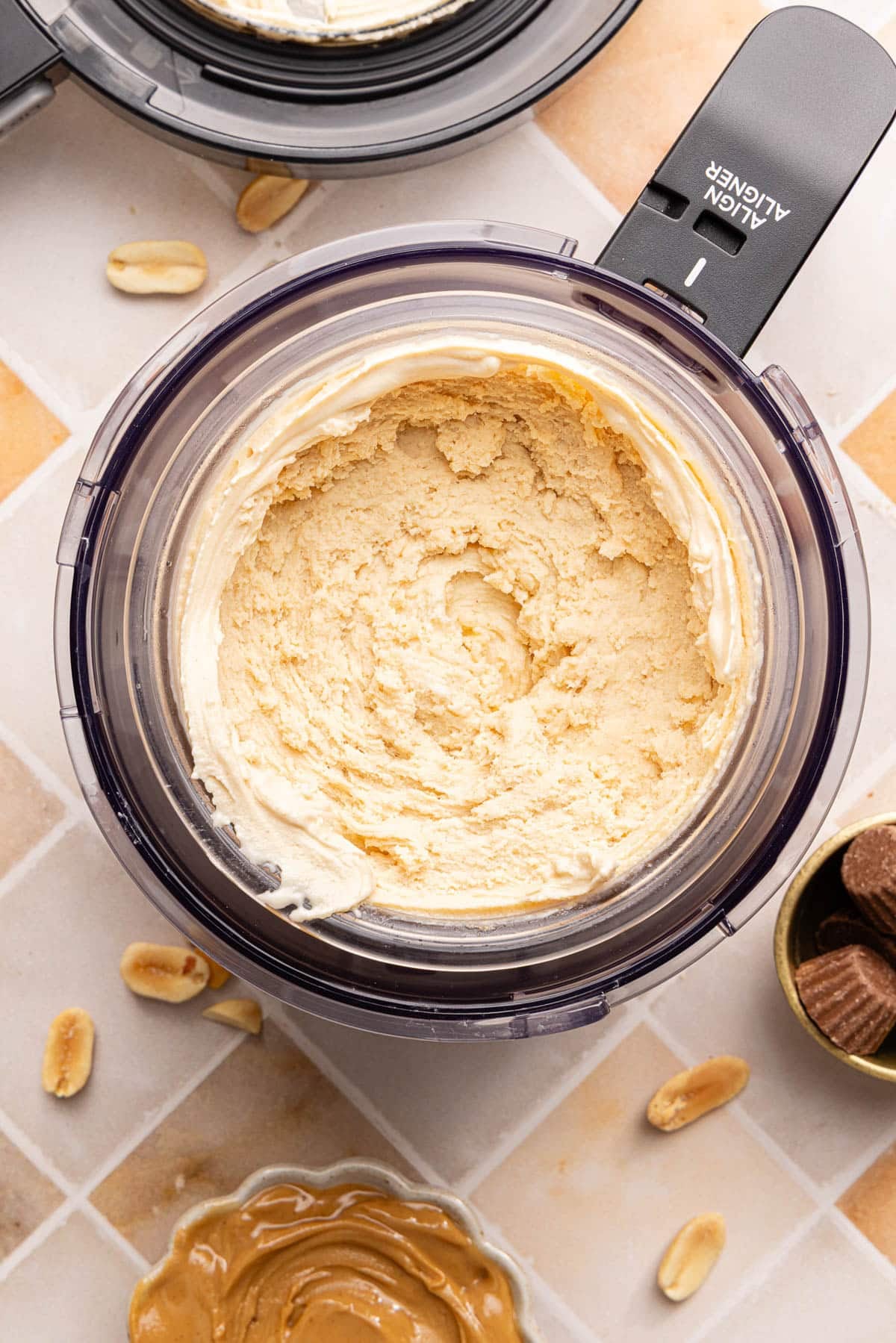 The frozen and mixed peanut butter ice cream in the ninja creami cup.