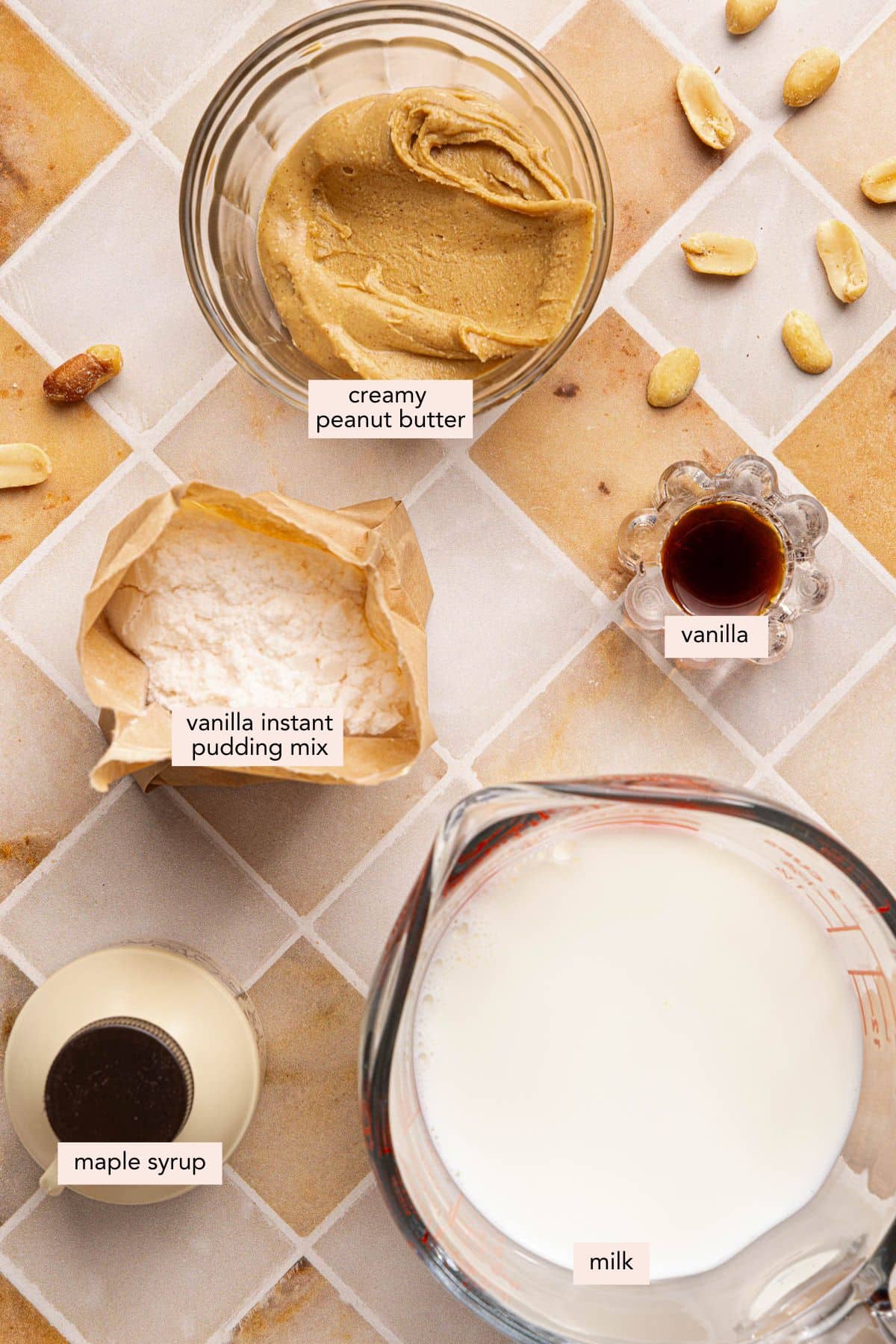 All of the ingredients for creamy peanut butter in bowls on a countertop.