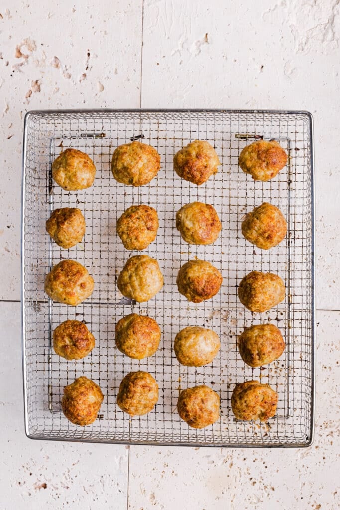 Cooked air fryer turkey. meatballs on an air fryer rack.