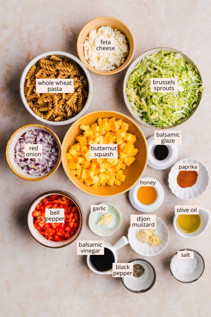 Winter pasta salad ingredients on a countertop with labels. 