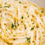 A close up shot of Greek yogurt Alfredo sauce garnished with parsley.