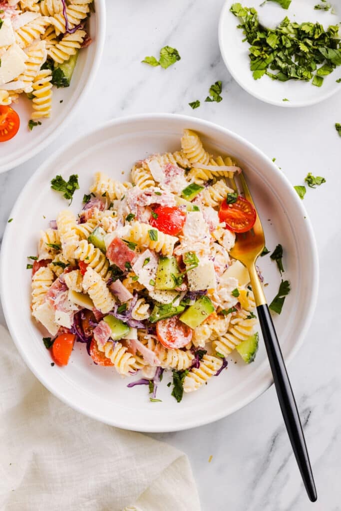Grinder pasta salad on a plate with a fork.