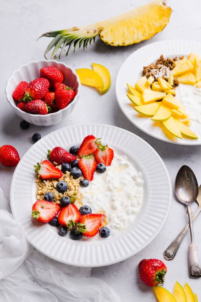 Creamy, high-protein cottage cheese bowls with fruit and crunchy granola. This simple recipe is easy, satisfying, and anything but boring. Cottage cheese and fruit bowls with various toppings like berries, granola, pineapple and mango.
