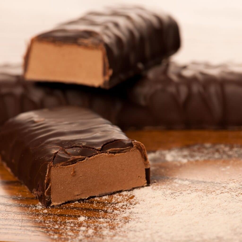 Protein bars stacked on a counter.