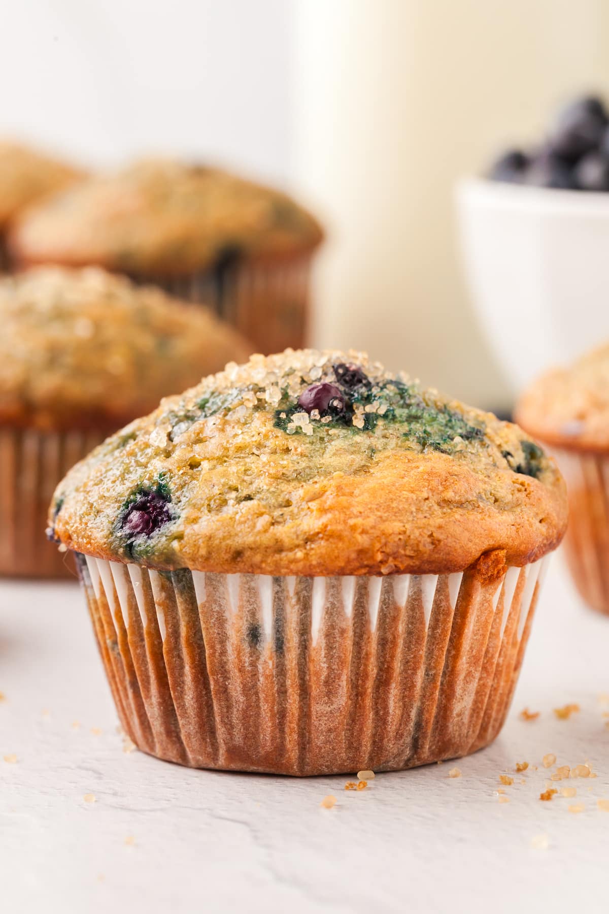 A blueberry yogurt muffin on a countertop.