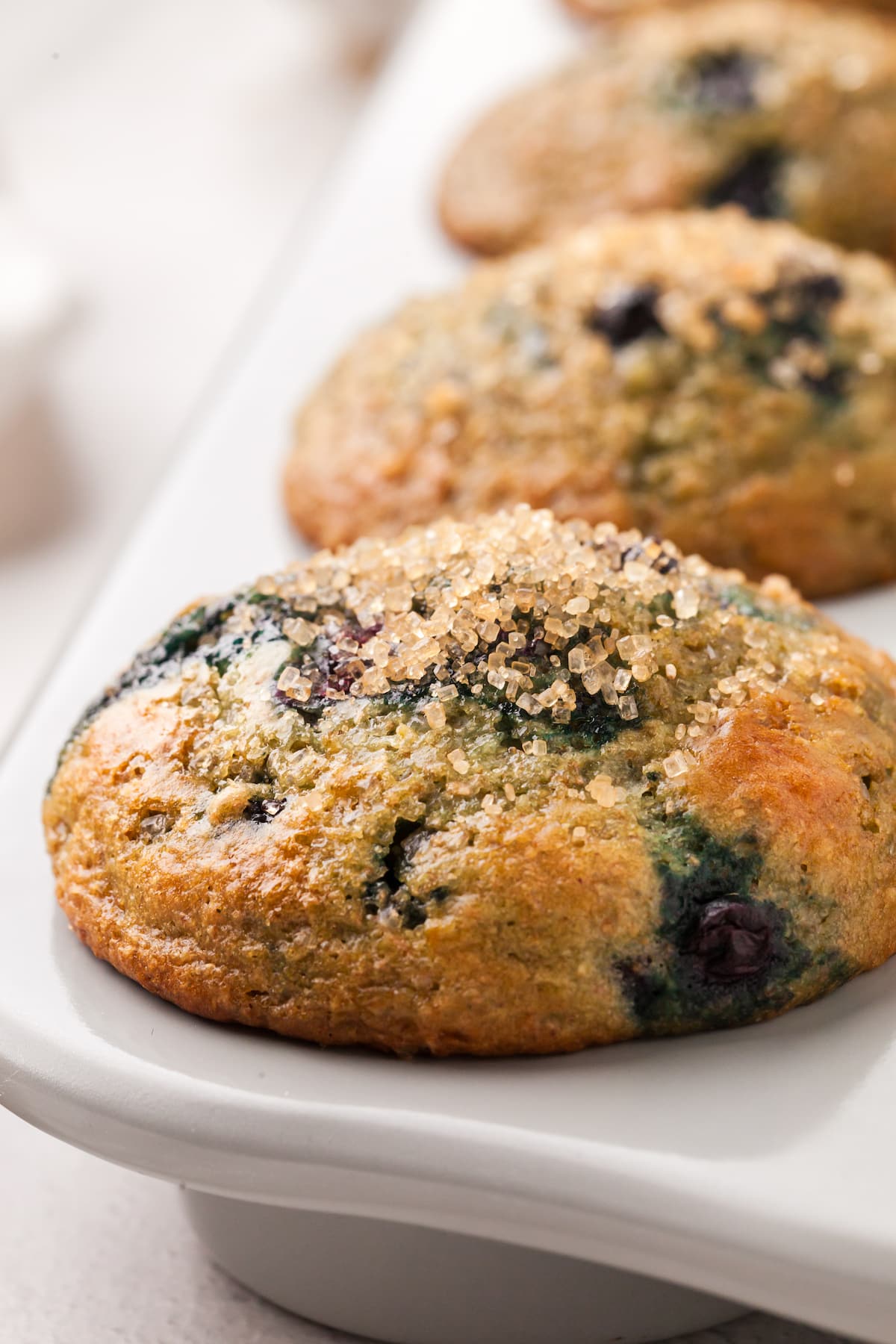 A close up shot of a blueberry muffin baked in a muffin pan.