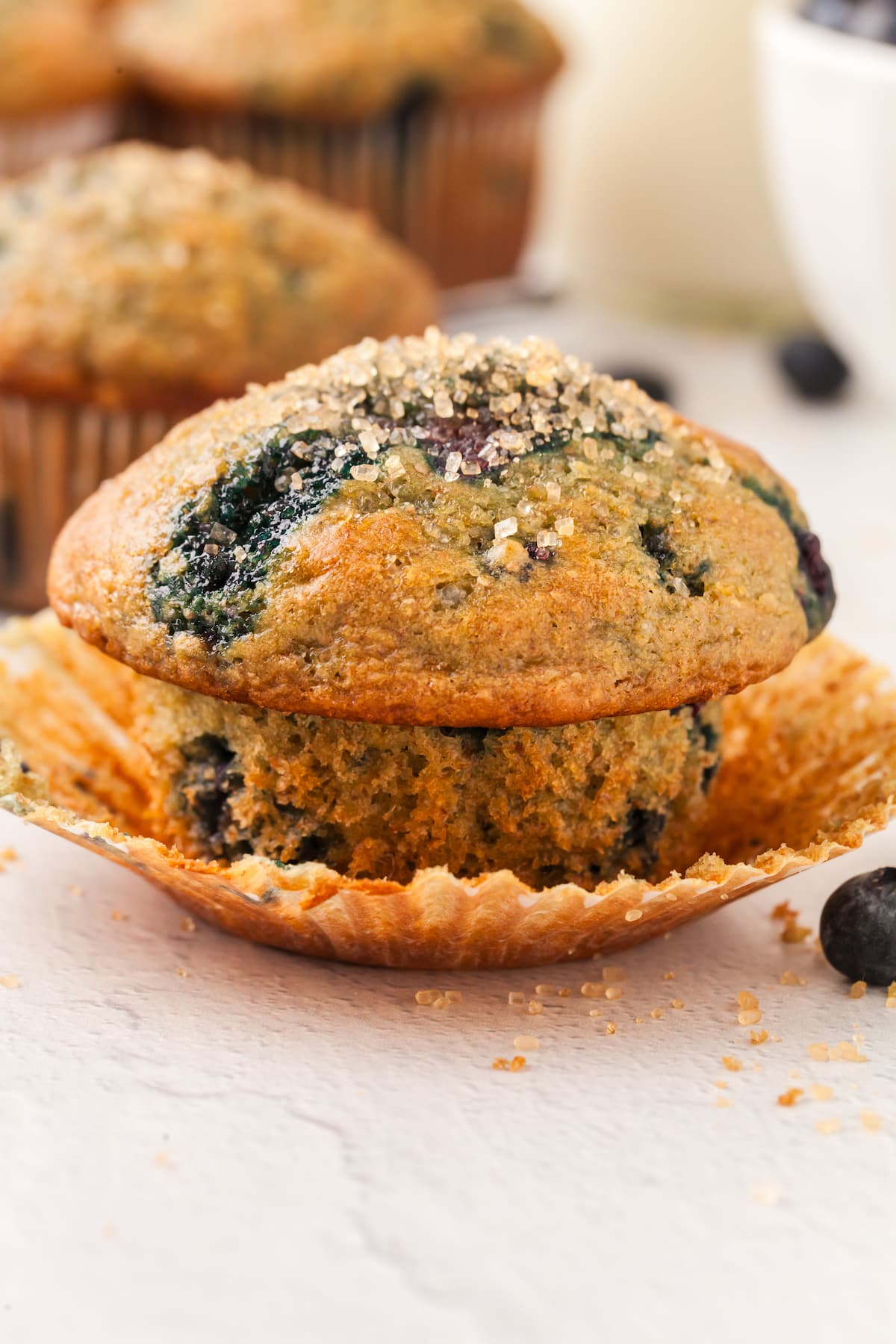 An unwrapped blueberry yogurt muffin on a countertop.