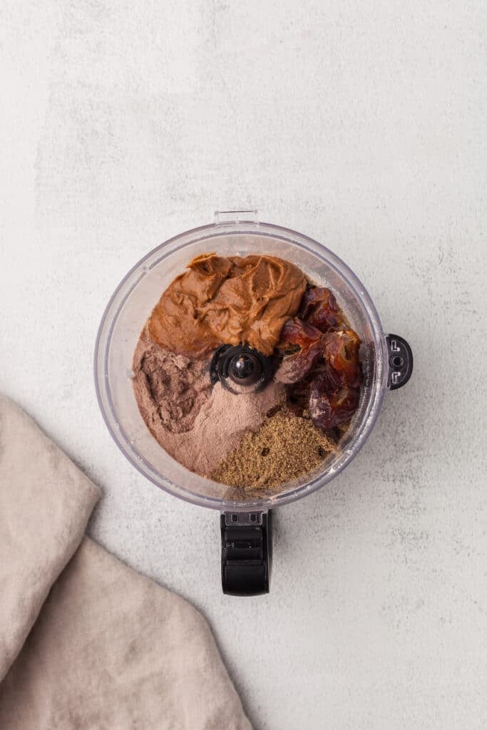 Coconut protein ball ingredients in a food processor.