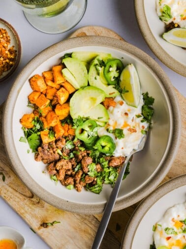 A bowl of air fried sweet potatoes, cottage cheese, ground beef, avocado and hot honey.