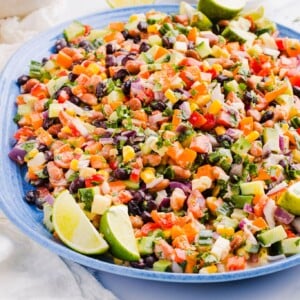 Creamy cowboy caviar on a large blue platter with tortilla chips.