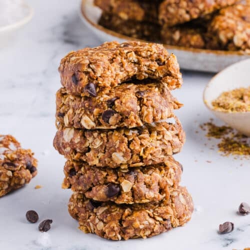 No bake protein cookies stacked on a countertop.