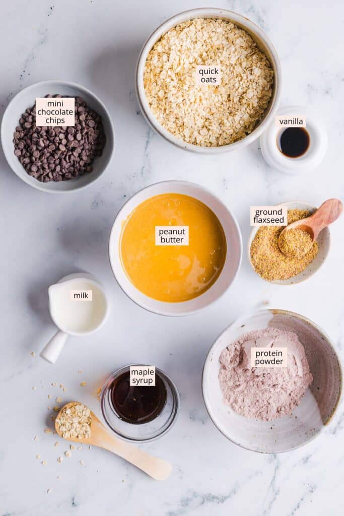 Ingredients for no bake protein cookies on a countertop with labels.