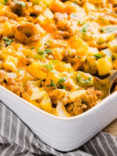 A close up shot of a no egg breakfast casserole in a baking dish.