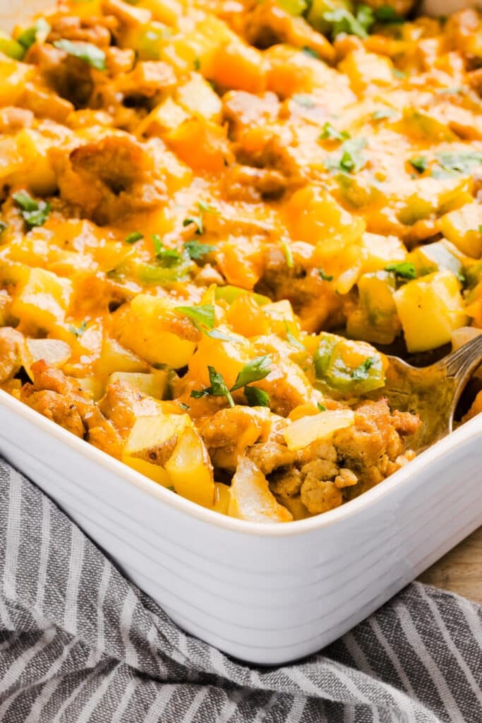 A close up shot of a no egg breakfast casserole in a baking dish.