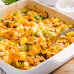 A scoop of no egg breakfast casserole in a baking dish.