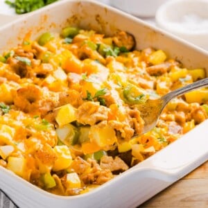 A scoop of no egg breakfast casserole in a baking dish.
