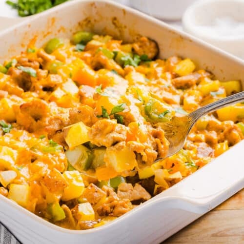 A scoop of no egg breakfast casserole in a baking dish.