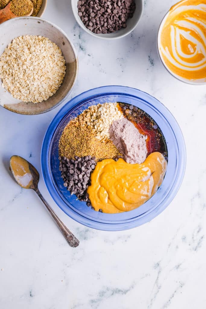 Ingredients for no bake protein cookies in a mixing bowl.