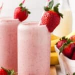 A strawberry banana smoothie garnished with a strawberry.