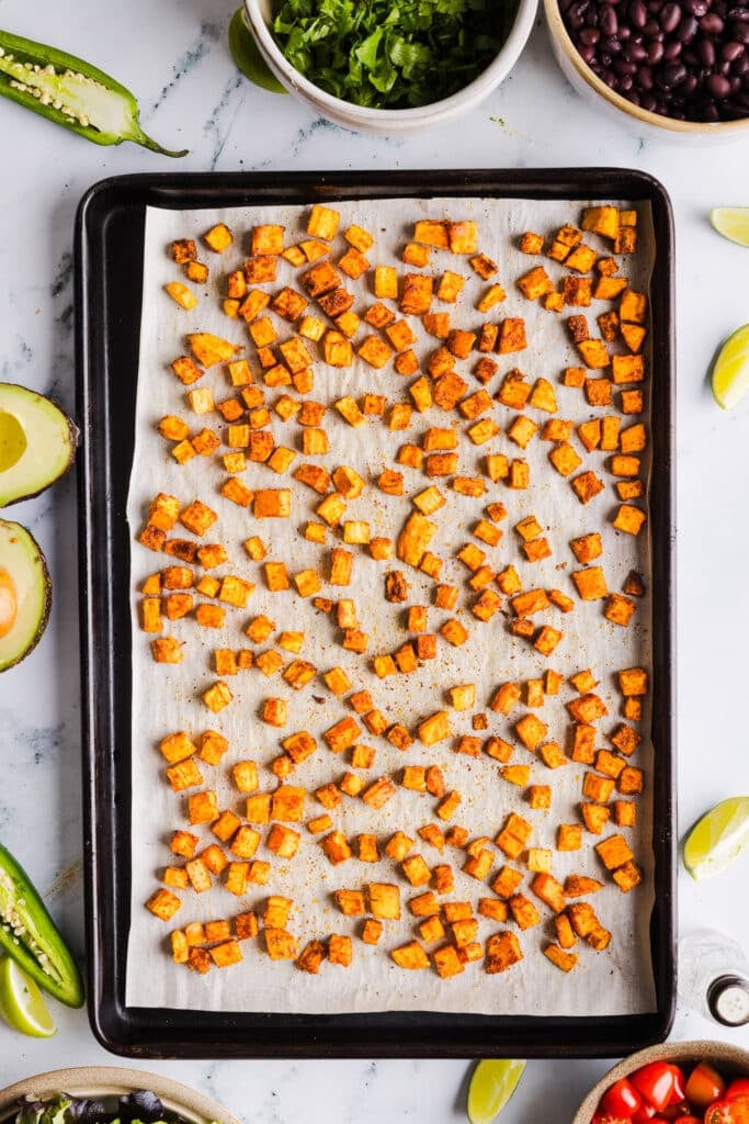Roasted sweet potatoes on a baking sheet.