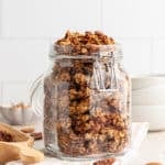 Vanilla nut granola in a clear jar.