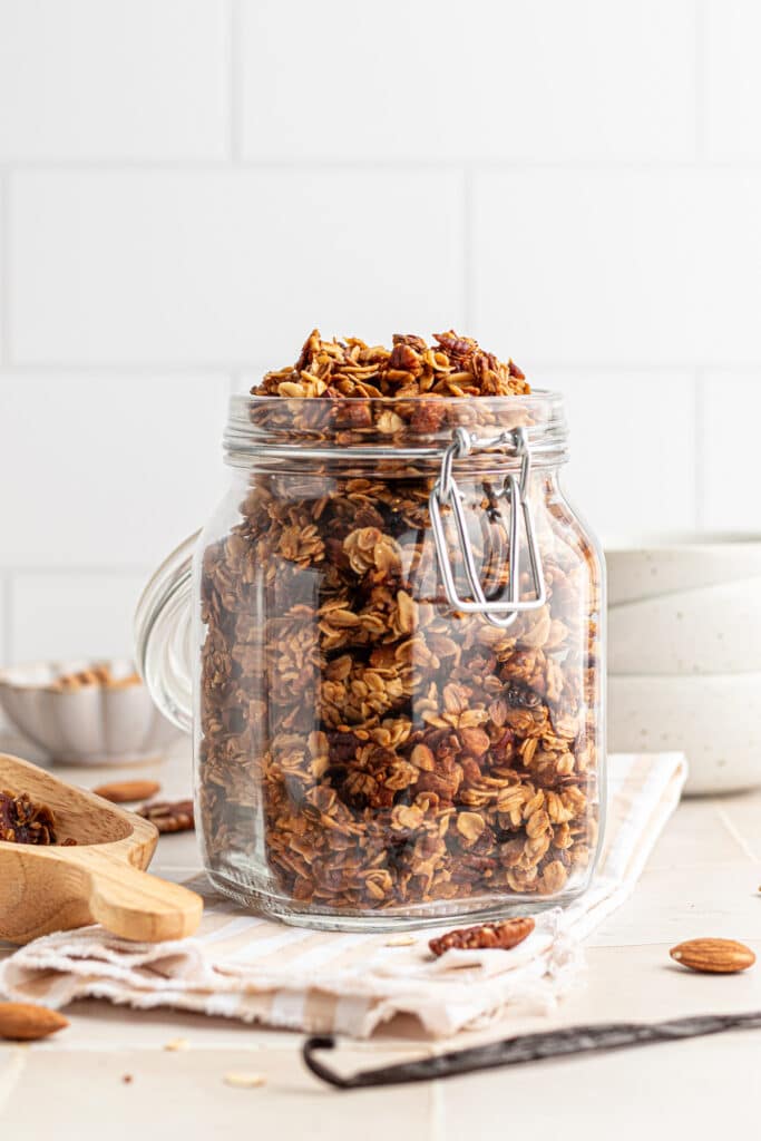 Vanilla nut granola in a clear jar.
