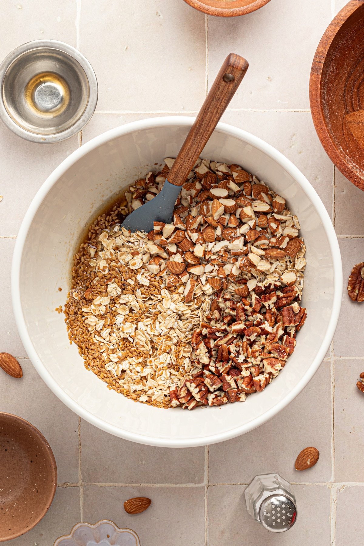 Oats, nuts and flaxseed mixed in a bowl for granola.