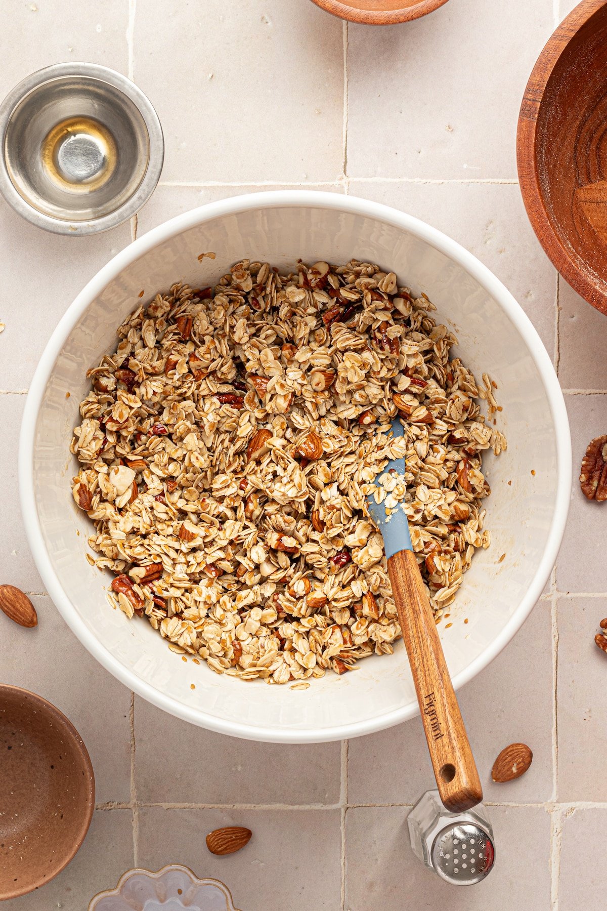 Oats, nuts and flaxseed mixed in a bowl for granola.