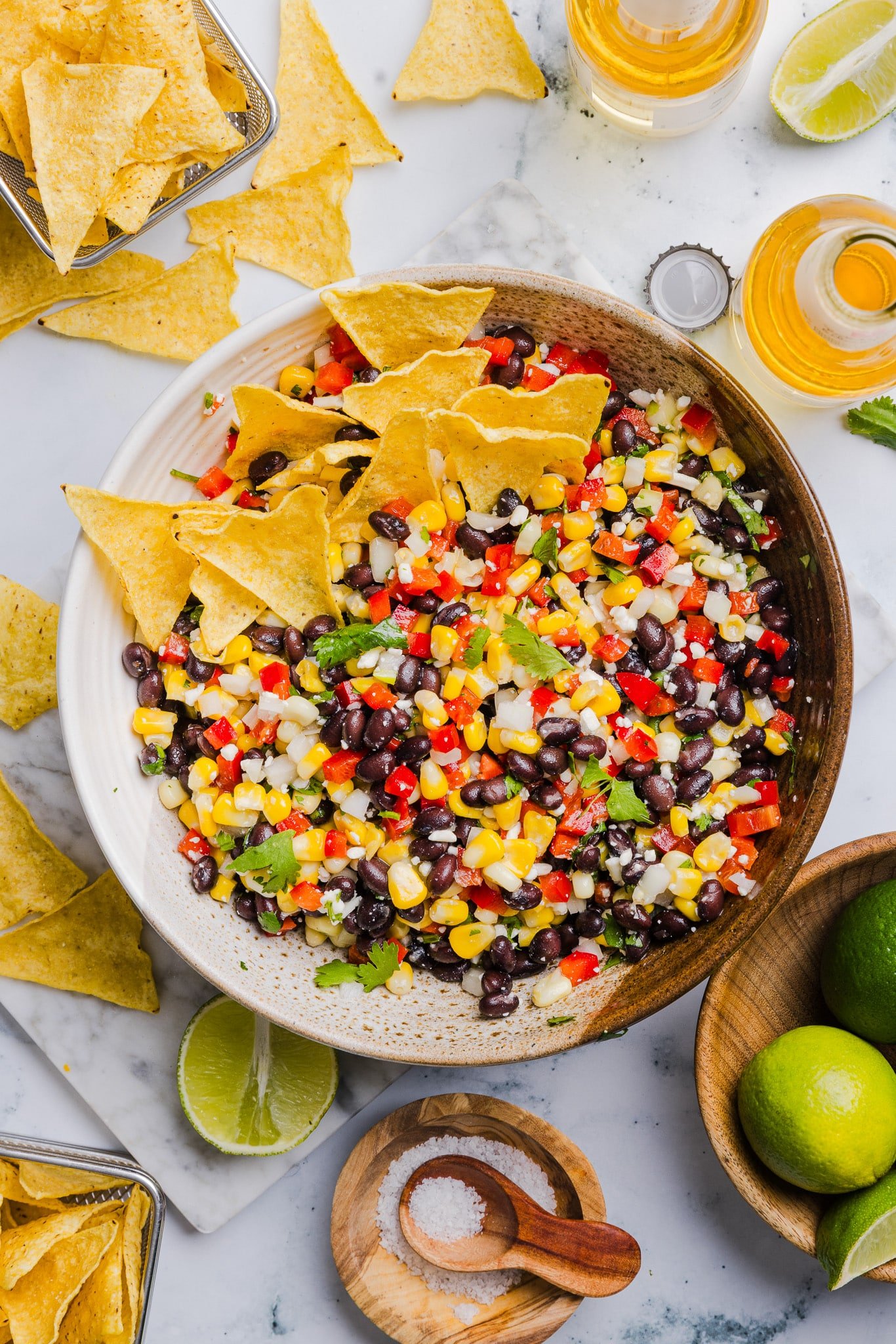 Black bean corn feta dip in a large bowl with tortilla chips.