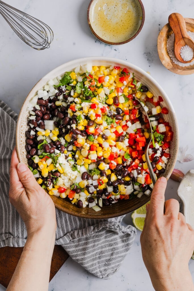 Black bean corn feta dip ingredients being mixed.